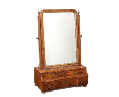 A George I walnut, crossbanded and featherbanded toilet mirror
The arched plate within a gilt gesso slip and moulded frame fl