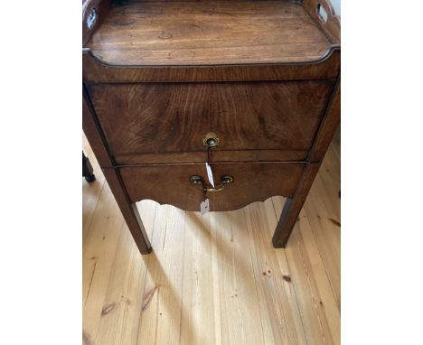 A George III mahogany gentleman's bedside commode
The rectangular top with pierced three-quarter gallery with turned roundels