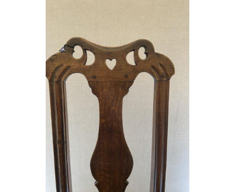 A pair of Queen Anne oak side chairs, Welsh
Each with pierced top-rail centred with a heart, solid vase splat and solid seat 