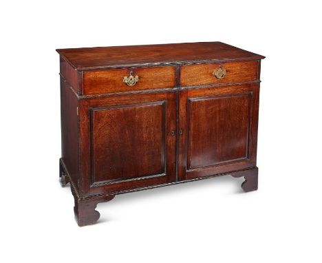 A George III mahogany side cabinet The rectangular moulded top above two frieze drawers and a pair of panelled doors enclosin