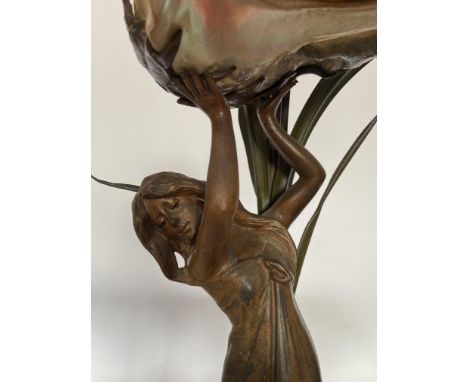 A late 19th century French Art Nouveau art metal table lamp
In the form of a maiden holding aloft a shade shell, amongst gree