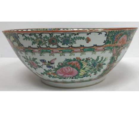 A 20th Century Chinese famille rose fruit bowl, the main body decorated with panels of figures in interior settings 29 cm dia