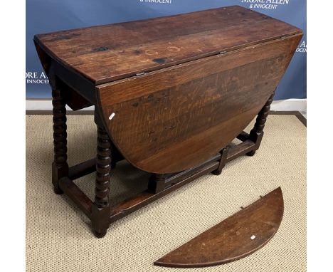 An oak gate leg drop leaf dining table in the 17th Century manner on bobbin turned supports 151 cm long x 122 cm wide x 75 cm