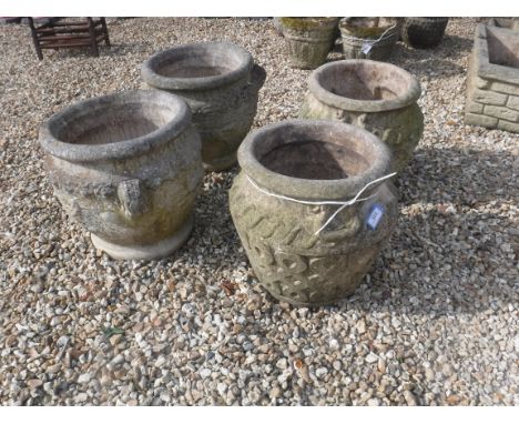 A pair of composite stone garden urns with Celtic knot style decoration 41 cm high together with a further pair of composite 