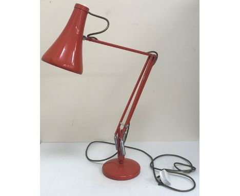 A mid 20th Century Herbert Terry anglepoise light in orange, raised on a circular base