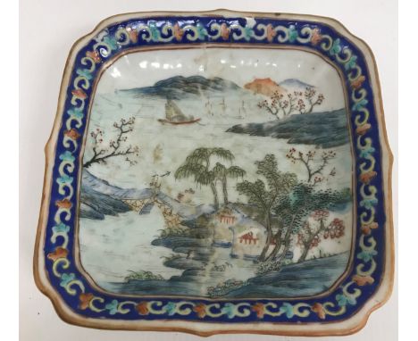 A 19th Century Chinese polychrome decorated square pedestal dish, the main body decorated with figure on a bridge and dwellin