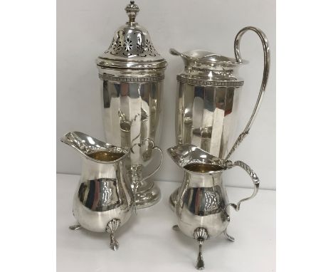 A silver sugar caster of faceted form, raised on circular stepped base, together with a matching cream jug of elongated helme