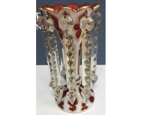 A late 19th Century Bohemian ruby glass white enamel and overlaid and gilt decorated table lustre with clear cut glass drops 