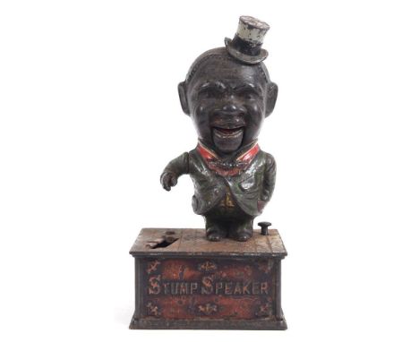 A LATE 19TH CENTURY 'STUMP SPEAKER' CAST IRON MONEY BANK modelled as a Negro gentleman wearing a top hat and a green-painted 