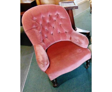 A VICTORIAN BUTTON UPHOLSTERED ARMCHAIR  on turned mahogany supports with ceramic casters, 88cm high 71cm wide 76cm deep