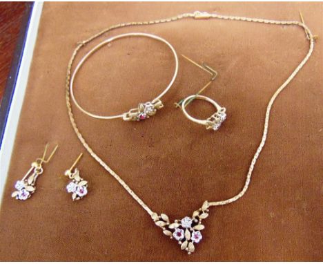 A SUITE OF DIAMOND AND RUBY SET 9 CARAT GOLD JEWELLERY also stamped '375', comprising: a necklace; a bangle; a ring; and a pa