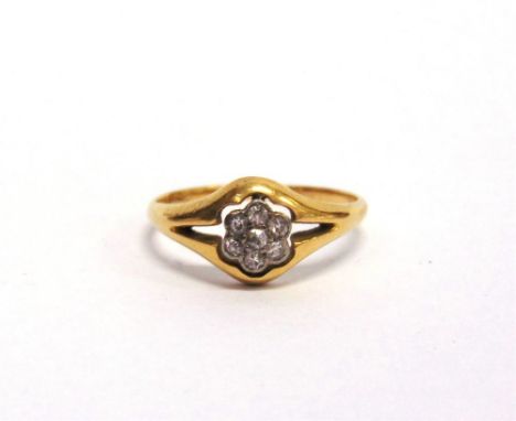 A DIAMOND CLUSTER RING stamped '18ct', set with seven single cut stones, finger size M1/2, 2.3g gross
