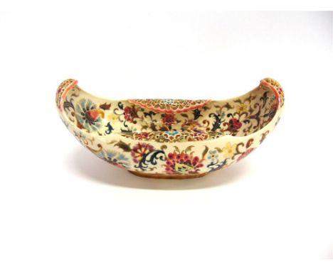 A ZSOLNAY PECS RETICULATED BASKET  of oval form, with polychrome painted scrolling floral decoration heightened in gilt, 31.5