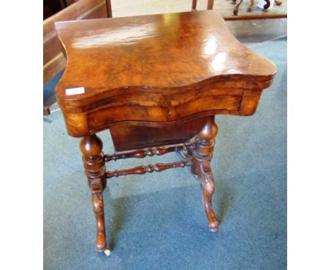 A VICTORIAN WALNUT GAMES/WORK TABLE,  the shaped top opening to backgammon, cribbage and chess board, over fitted drawer and 