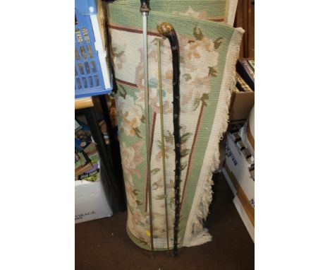 A WOOLLEN RUG TOGETHER WITH A WALKING STICK, ETC
