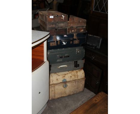 A TIN TRUNK TOGETHER WITH A QUANTITY OF VINTAGE SUITCASES AND A VINTAGE WOODEN STORAGE DRAWERS 