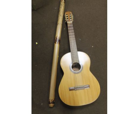 AN ACOUSTIC GUITAR TOGETHER WITH A DIDGERIDOO, ETC  