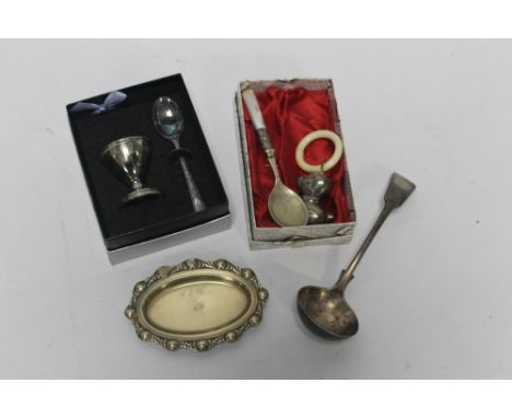 A BOXED CHILD'S BABY RATTLE, together with a teething ring and other sundry plated  items