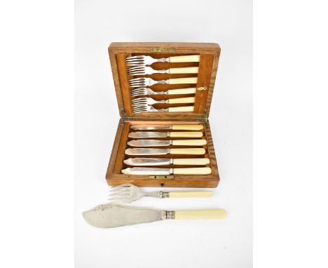 An oak cased set of fish knives and forks for six setting, the set with resin handles, enclosed in a velvet lined fitted inte