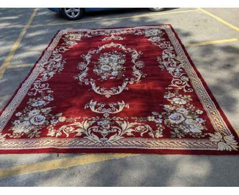 A machine made carpet with foliage on a red ground 300cm x 400cm Location: 