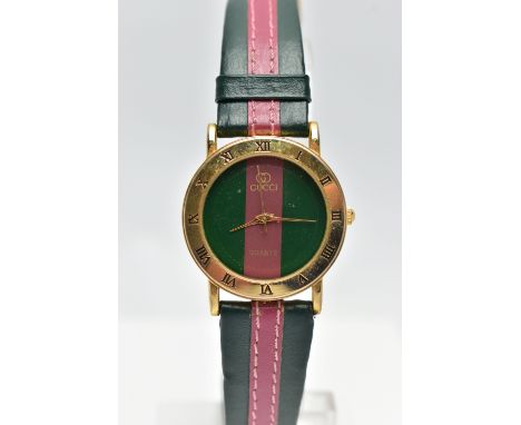 A 'GUCCI' QUARTZ WRISTWATCH, featuring a round green and burgundy stripped dial signed 'Gucci quartz', gold hands, with a Rom