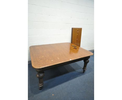 A VICTORIAN OAK WIND OUT DINING TABLE, with a double winding screw, three additional leaves, on six shaped and fluted legs, w