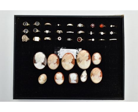 A BLACK RING DISPLAY TRAY WITH ASSORTED SILVER AND WHITE METAL RINGS, to include four signet rings, each set with oval cut on