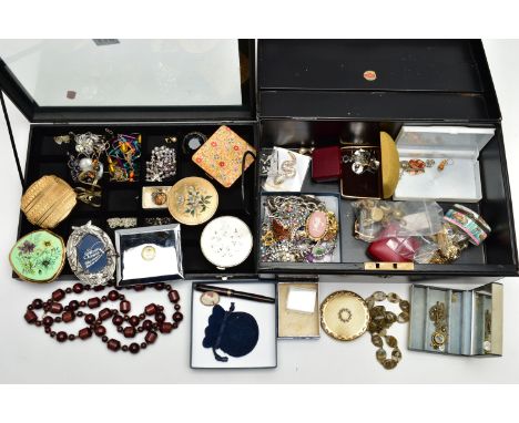 A BLACK TIN AND A DISPLAY CASE WITH COSTUME JEWELLERY, to include paste set brooches, several boxes, a small photo frame, a w