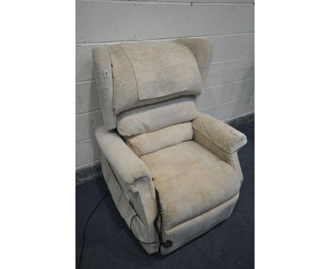 A CREAM ELECTRIC RISE AND RECLINE ARMCHAIR (PAT pass and working) (condition:-some stains to fabric, with owner's manual, one