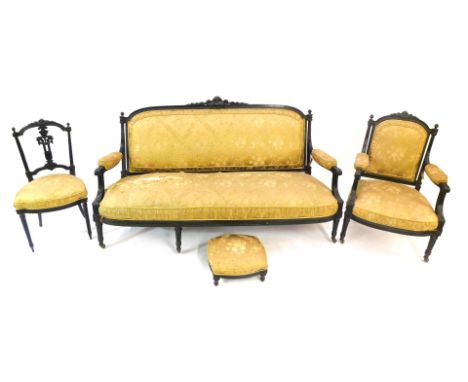 A 19thC ebonised salon suite, comprising show frame sofa, decorated with scrolls, ribbons, flowers, etc., on turned fluted le