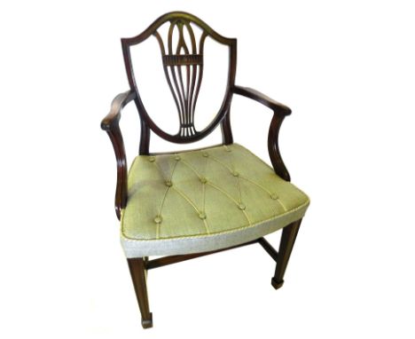 A mahogany open armchair in George III style, the shield shaped back with a pierced splat, with shaped arms, button padded se