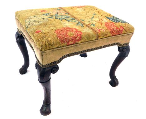 An 18thC walnut stool, the padded seat upholstered in 18thC tapestry fabric, on faceted cabriole legs and pad feet, 50cm x 38