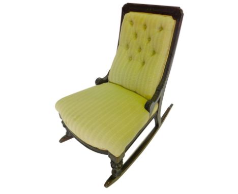 A 19thC mahogany rocking chair, with a button back, padded seat, on turned and fluted supports, possibly American.