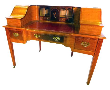 A late 20thC mahogany and satinwood Carlton House desk by Tom W Skeels, the raised back with two hinged compartments, one bea