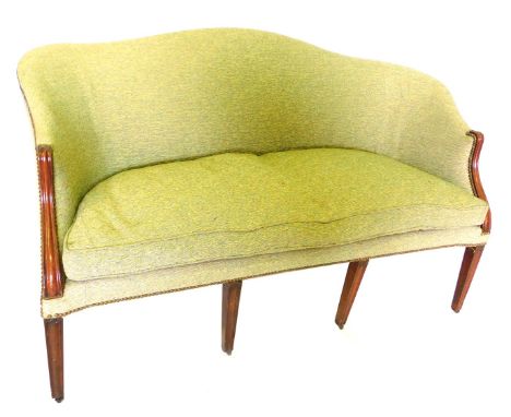 A mahogany sofa in George III style, with shaped back, large loose cushion, on square tapering channelled legs.