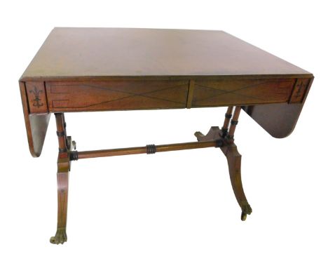 A mahogany and ebony strung sofa table in Regency style, the rectangular top with a rosewood cross banded border, above two f