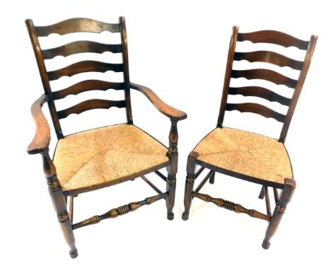 A set of six late 19th/early 20thC country made oak ladder back dining chairs, each with a rush seat, on part turned legs and