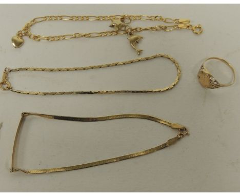 A 9ct gold small charm bracelet with attached dolphin, heart and star charms; a 9ct gold bracelet; a 9ct gold small medallion