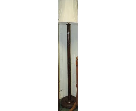 A Chinese hardwood standard lamp, with spiral carved flower head decoration.