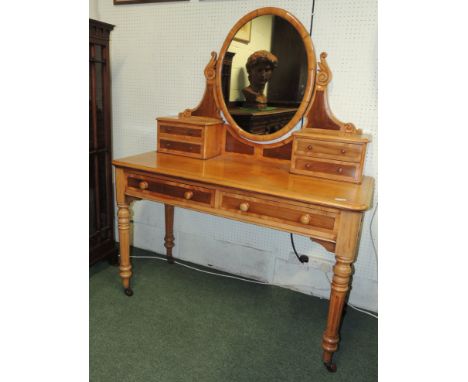 A Victorian satinwood Duchess style dressing table, having oval mirror, jewellery drawers, two frieze drawers and on turned, 