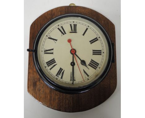 A bulkhead timepiece having cream dial with red sweep seconds hand, in black painted circular case and now mounted on wood pa