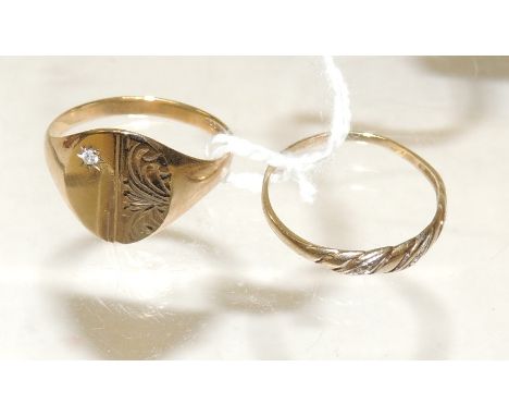 A 9ct gold, oval panel signet ring, engraved decoration and set with tiny diamond, size R; and a thin 9ct gold twist design r