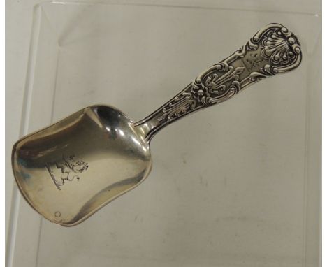 A Victorian silver caddy spoon with shell and scroll decoration to the handle and engraved rampant lion crest to the bowl and