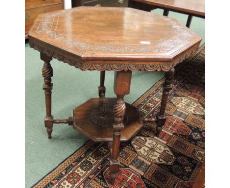 A late Victorian carved oak octagonal centre table with turned supports and octagonal lower shelf, 70cm high. 