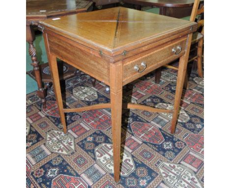 An Edwardian mahogany envelope card table, with line inlaid and crossbanded decoration, having single drawer and on four squa