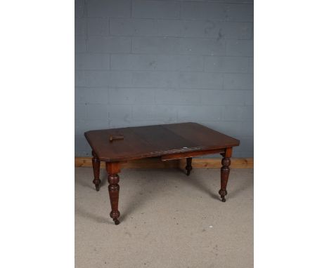 Victorian extending dining table, with chamfered corners, one extra leaf and winder, raised on tuned legs and castors, 145cm 