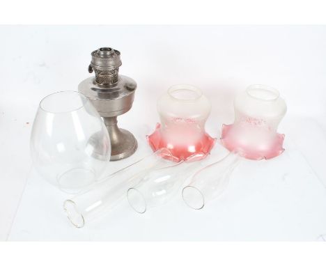 Pair of frosted and cranberry glass shades, with foliate decoration, together with a metal oil lamp base, a clear glass shade