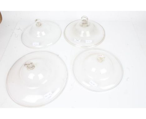 Four clear glass oil lamp smoke bells, the largest 30.5cm diameter (4)