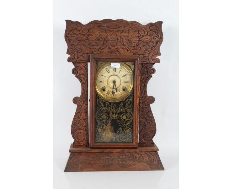 Late 19th/early 20th century American kitchen or mantel clock, having press moulded 'Gingerbread' case, with single glazed do