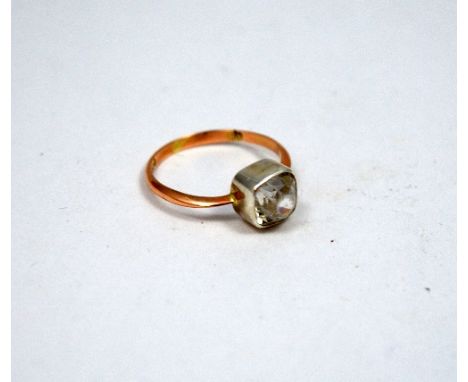 A RING, with old mine cut rock crystal to the tapered rose gold coloured band, ring size O